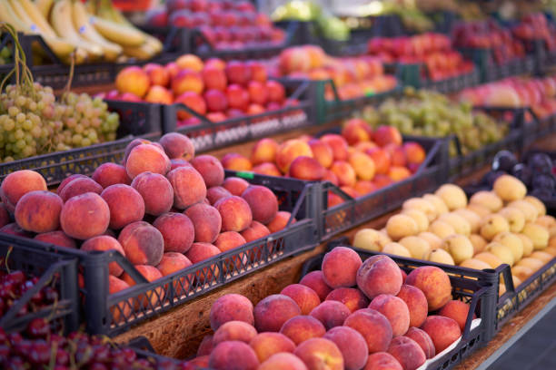 istock Fruit bazaar peaches grapes apricots ripe juicy lie plastic box showcase. 1257220354