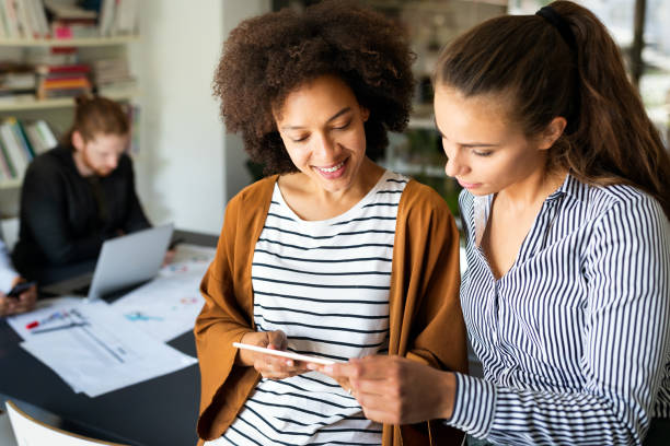 istock Happy young business people colleagues talking working in office 1257221644