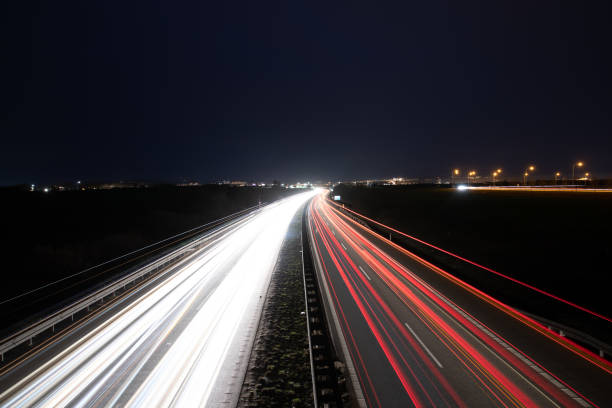 istock Highway light car trails leading from passing cars during night. 1257223185