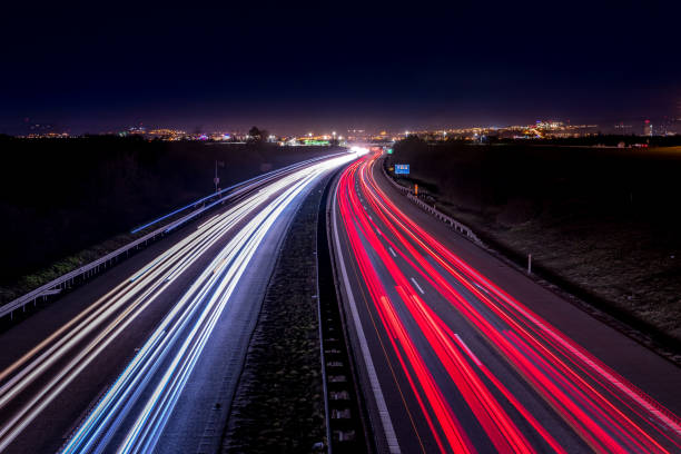 istock Highway light car trails leading from passing cars during night. 1257223191