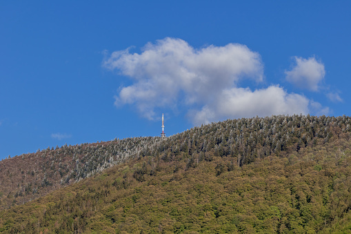 Mountainous landscape and Radhost hill during a sunny day with clouds in the sky. in Czechia, Zlin Region, Valasske Mezirici