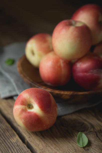istock Ripe peaches on a wooden table 1257224677