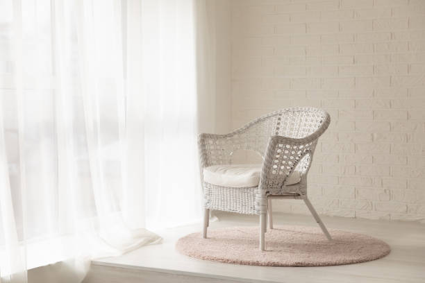 istock White wicker armchair standing in empty modern room with carpet 1257226829