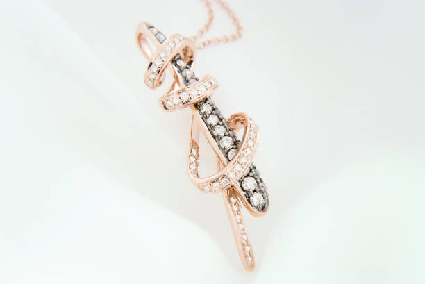 istock Rose Gold Pendant With Diamonds On Soft White Background 1257227005