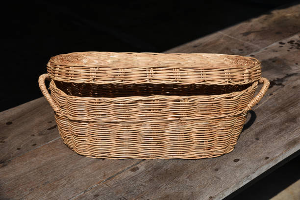 Rattan wicker basket handmade Rattan wicker basket on the old wood table . Handmade moses basket stock pictures, royalty-free photos & images