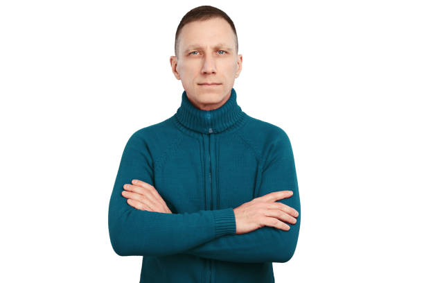 istock Serious average age man with crossed arms in blue sweater isolated on white background 1257230790