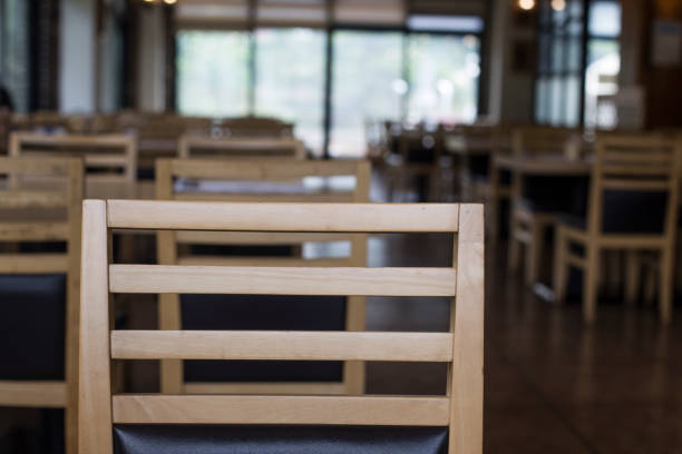 istock Wood table top on blur empty restaurant interior background. 1257231890