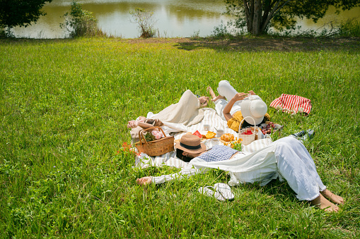 Asian woman friends, they are resting and are having a picnic.