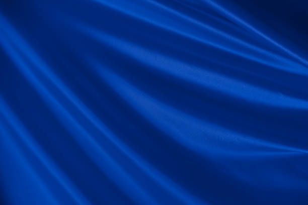 istock Beautiful elegant wavy classic blue satin silk. 1257234106