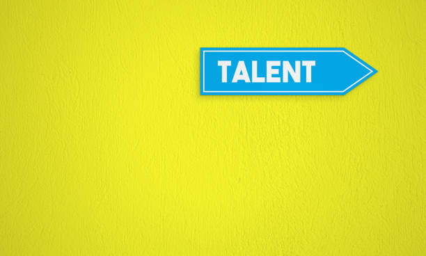 istock Talent Directional Sign On The Yellow Wall Background 1257236766