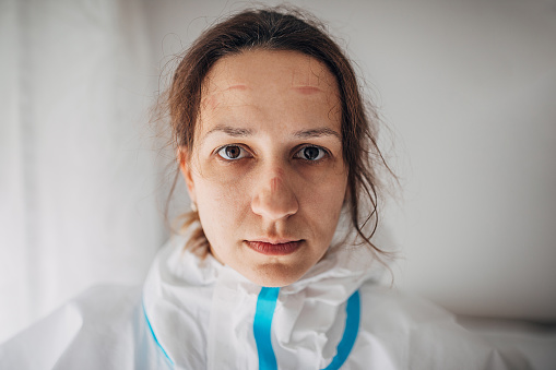Portrait of female doctro in protective suit in hospital.