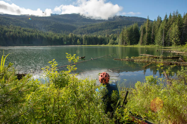 istock Mountain e-biker relaxes by lakeshore 1257243250