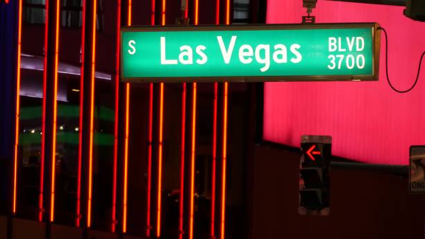 fabulos las vegas, traffic sign glowing on the strip in sin city of usa. iconic signboard on the road to fremont street in nevada. illuminated symbol of casino money playing and bets in gaming area - downtown las vegas fremont street experience nevada las vegas metropolitan area imagens e fotografias de stock