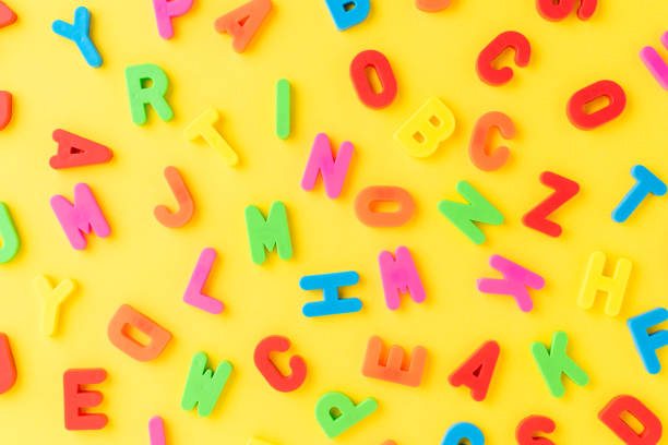 istock Colourful letters on yellow background - pattern. School background 1257244431