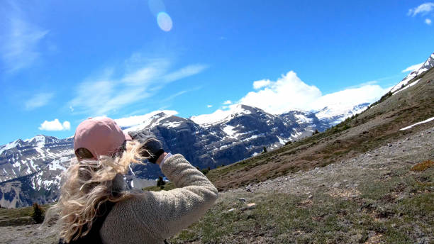 istock Woman hikes up windy mountain ridge 1257245840