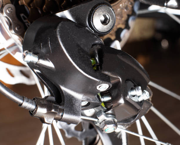 istock Gearshift on mountain bike MTB, chain moves on rings. Changes speeds. Shift gears on bicycle crank. Work of chain drive chainset. Front derailleur. Macro closeup low angle shot. Wheel spins and turns 1257246949