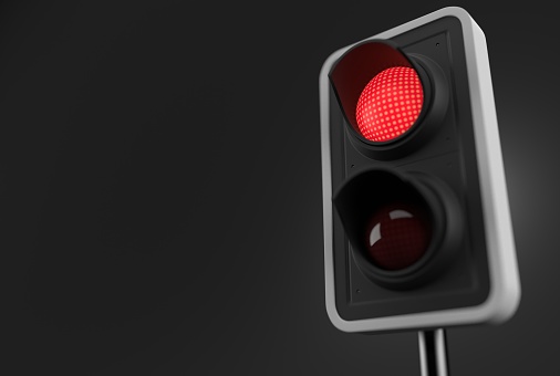 Red traffic light on grey background. 3d illustration