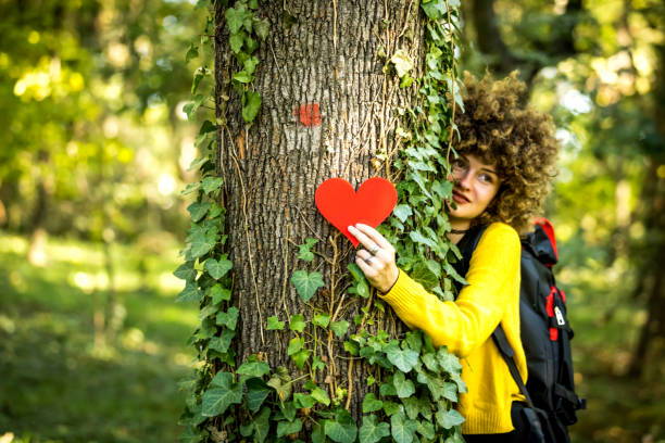 istock Woman hugging tree outdoors 1257248386