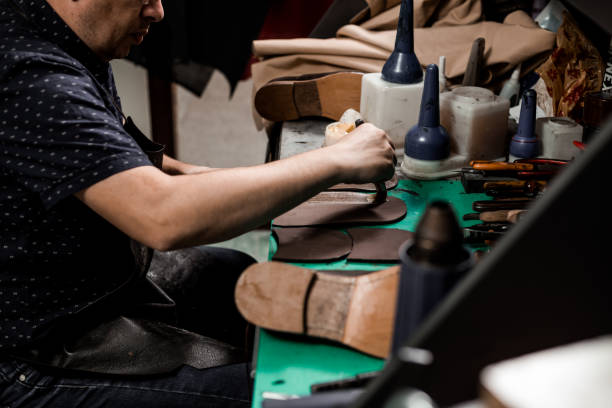 istock Cobbler repairing shoes 1257248731