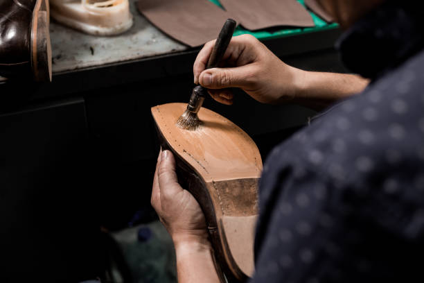 istock Cobbler repairing shoes 1257248750