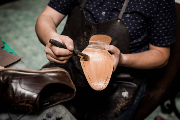 istock Cobbler repairing shoes 1257248755