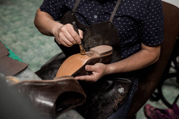 istock Cobbler repairing shoes 1257248757