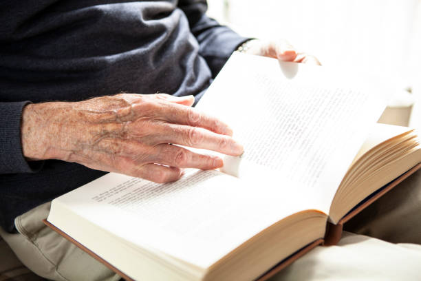 istock Male senior hands holding a book 1257250192