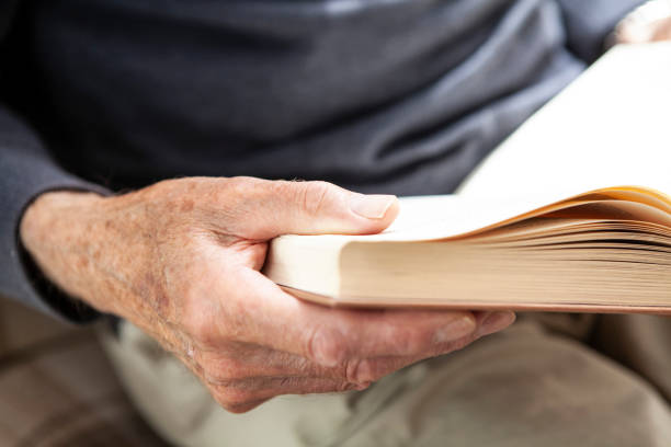istock Male senior hands holding a book 1257250198