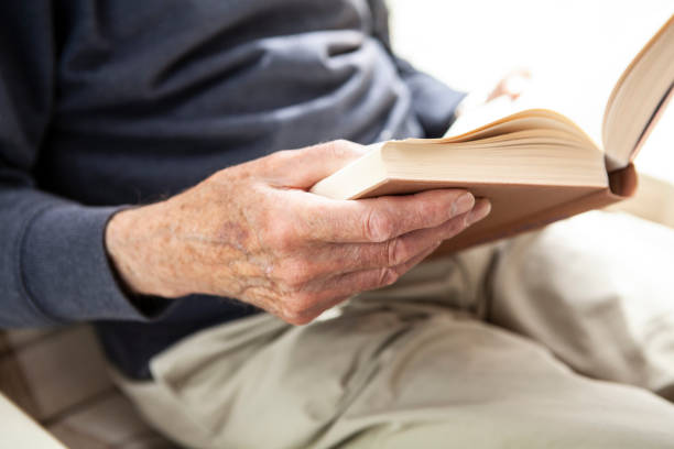 istock Male senior hands holding a book 1257250202