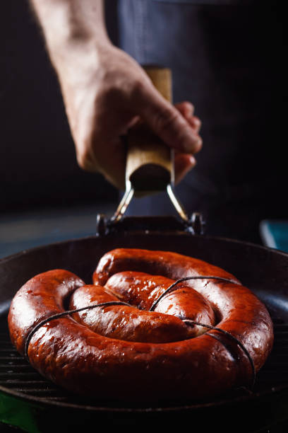 istock Homemade sausage cooked on a grill, with tomatoes. 1257253654