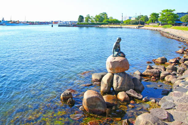 Little mermaid statue, Copenhagen, Denmark. Langelinie promenade with the iconic little mermaid statue & landmark in the foreground and the harbour in the background, Copenhagen, Denmark. oresund region photos stock pictures, royalty-free photos & images