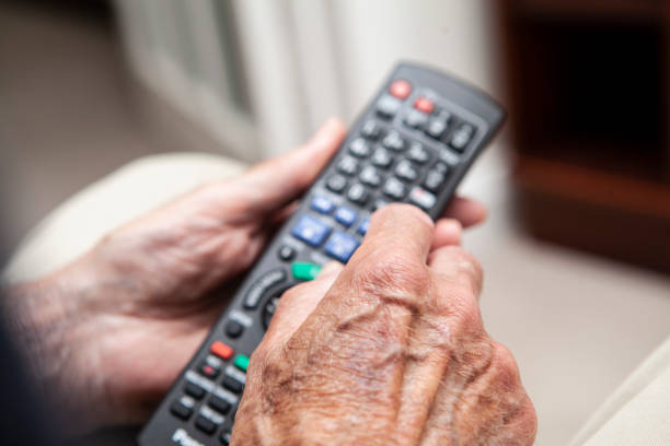 istock Male senior hands holding a tv remote control 1257255484