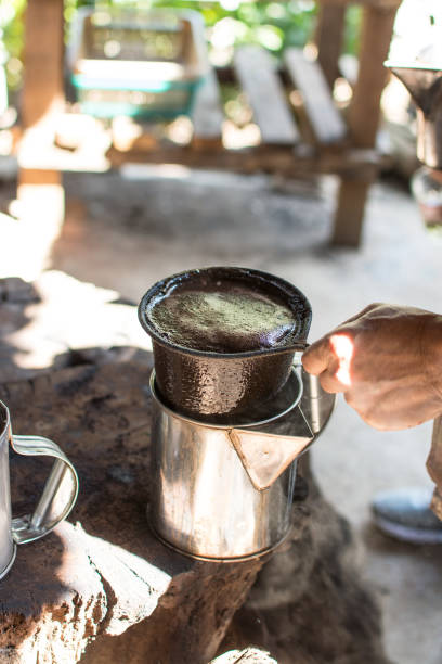 istock hand holding coffee  bag filter while filtering traditional Thai coffee. 1257255566