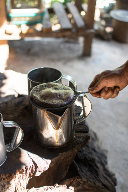 istock hand holding coffee  bag filter while filtering traditional Thai coffee. 1257255577