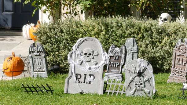 Scary festival decorations of a house, Happy Halloween holiday. Classic garden with Pumpkin, Bones and Skeleton. Traditional party decor. American culture Scary festival decorations of a house, Happy Halloween holiday. Classic garden with Pumpkin, Bones and Skeleton. Traditional party decor. American culture. haunted house stock pictures, royalty-free photos & images