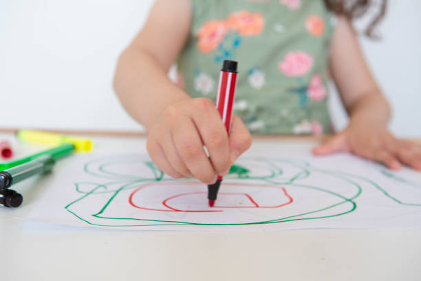 istock Little girl drawing on white paper 1257257079