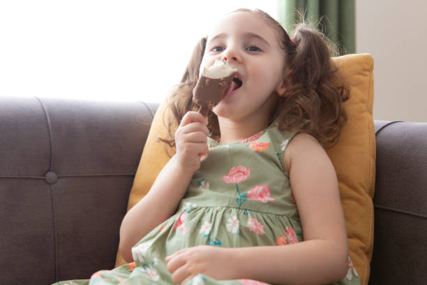 istock Cute girl eating ice cream 1257257166