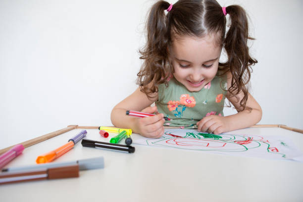 istock Little girl drawing with pencil 1257257330