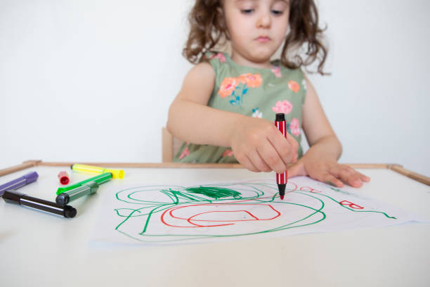 istock Little girl drawing with pencil 1257257387