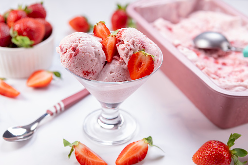 Scooped homemade strawberry ice cream ready to be served.