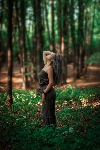 istock beautiful girl standing in the forest 1257261766