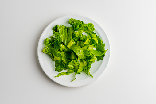 Romaine lettuce. Ingredients for restaurant cooking from farmers markets. Photographed on white background. Fresh Fruits & vegetables from farmers market. Classic ingredients, garnishes used in cooking. Meats, veggies, herbs & spices.