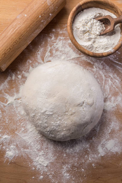 istock Freshly prepared yeast dough for pizza or bread on wooden background. 1257262997
