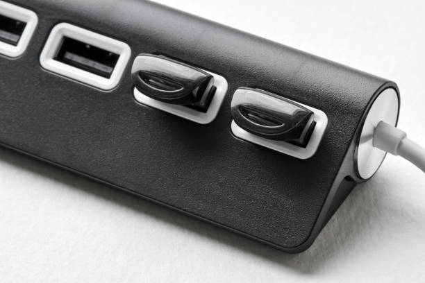 istock Black portable USB hub for four connections with usb flash drives on a white background. Bus povered. Closeup, selective focus 1257265527