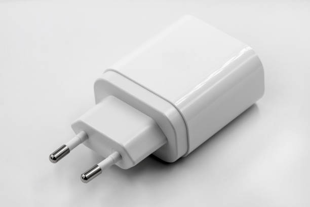 istock White socket travel charger for three USB ports output. USB electronics device charger on white background. Closeup. 1257265696