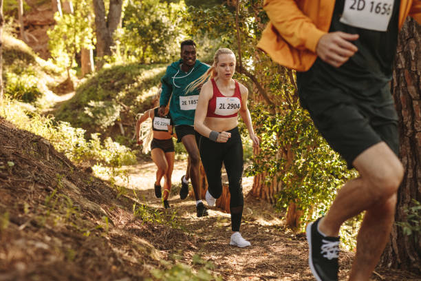 istock Group of athletes run uphill trail 1257266647