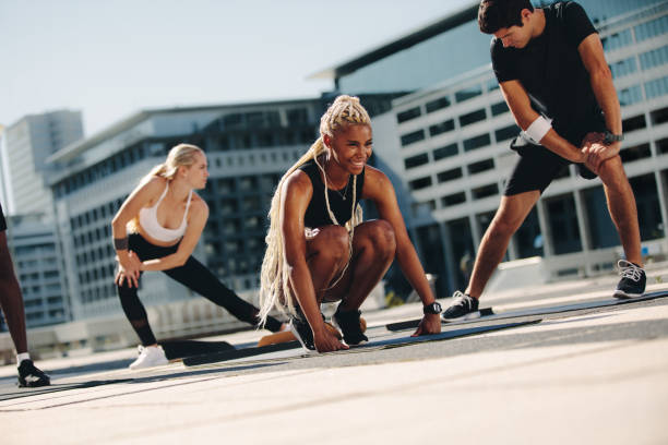 istock Group of people exercising together in the city 1257266708