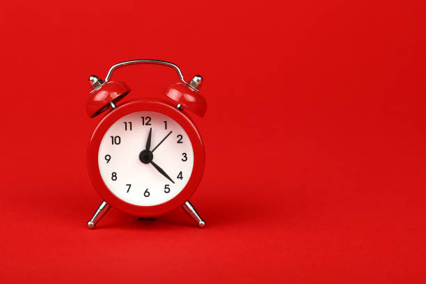 istock Close up one red alarm clock over red background 1257267022