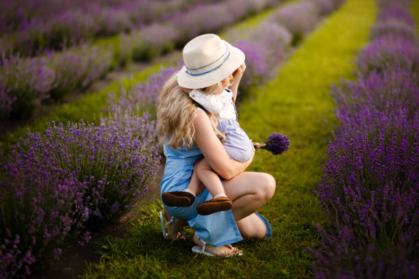 istock Little boy walking with his mother on a lavender field. 1257268114