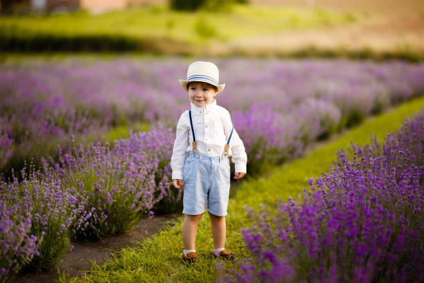 istock Little boy walking on a lavender field. In a stylish hat. 1257268155